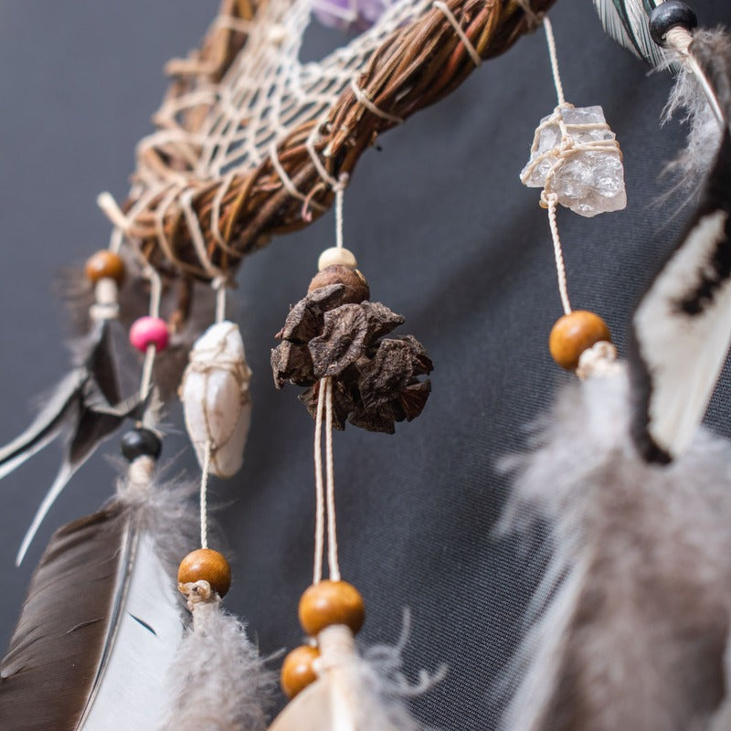 Handmade white dreamcatcher crafted with natural materials and healing crystals for a tranquil and stylish atmosphere.